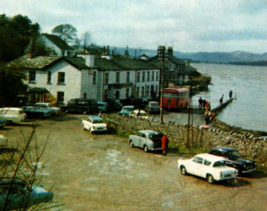 A Ribble bus on its way to Arnside and other vehicles, including a Bedford Dormobile and several Ford Anglias, are cut off by the high tide at Storth Road End on March 27 1967.