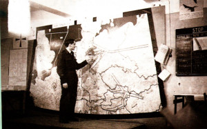 Mrs. Hughes’ husband at a Lubeck briefing during the Berlin Airlift. The map shows the corridors into the city.