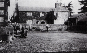 The tractor seen on the left of this picture was the first one on Ryefield Farm. The shadow in the foreground, from the barn behind, runs to the stables, from where Kenneth Orchard had to dash to safety from the geese. The lower building in the yard is where the Lister and pump were housed. The coat with the cartridges was hung on the wall next to the scullery yard gate.