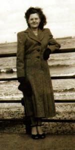 A younger Hilda Williams shows off her footwear on a bright and breezy day at the seaside.