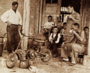 Ernest and his two SOE colleagues with Yugoslavian boys and the motorcycle dropped in by parachute. The team were later air-lifted out along with two American airmen they had rescued from their shot-down aircraft.