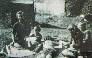 Peggy and her own children with the old well in the background.