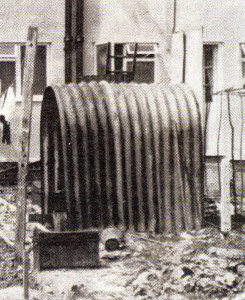 An old Anderson air-raid shelter kept on as a garden shed in the 1950s.