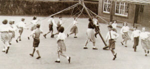 Shouts of “Timber! ’’ greeted the Maypole’s collapse. Anthony Hunt is furthest to the left, well away from danger!