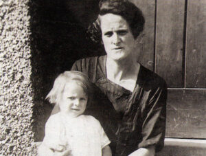 Granny Hunts and daughter Rose sitting on the steps in front of their home.