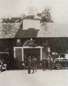 The Army tells the author’s father (on left) of its plans for the use of his premises in 1940.