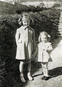 Ann (right) and her elder sister Pat with matching home-made blue coats in 1941.