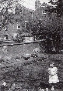 In the walled garden at Oxford in 1933. No mud pies today, because Daddy is in the background!
